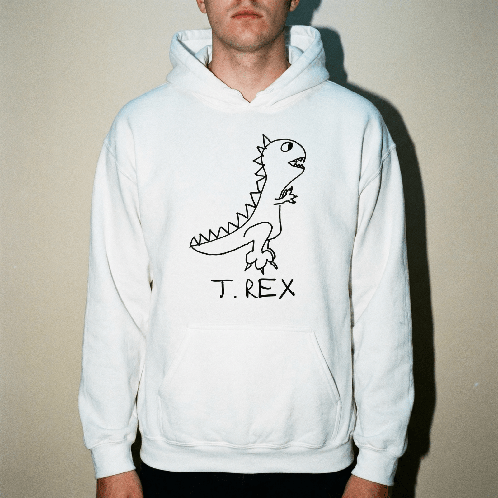 Studio torso view of a man wearing a lo-fi T. Rex Hoodie