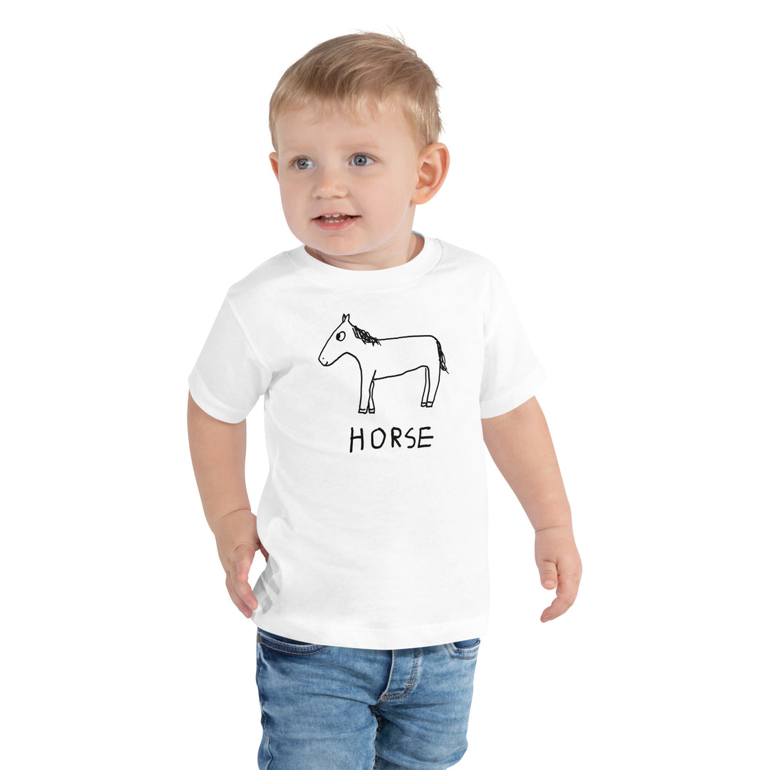 Toddler wearing a white toddler t-shirt with a lo-fi hand-drawn horse graphic and "HORSE" text on a white background. 