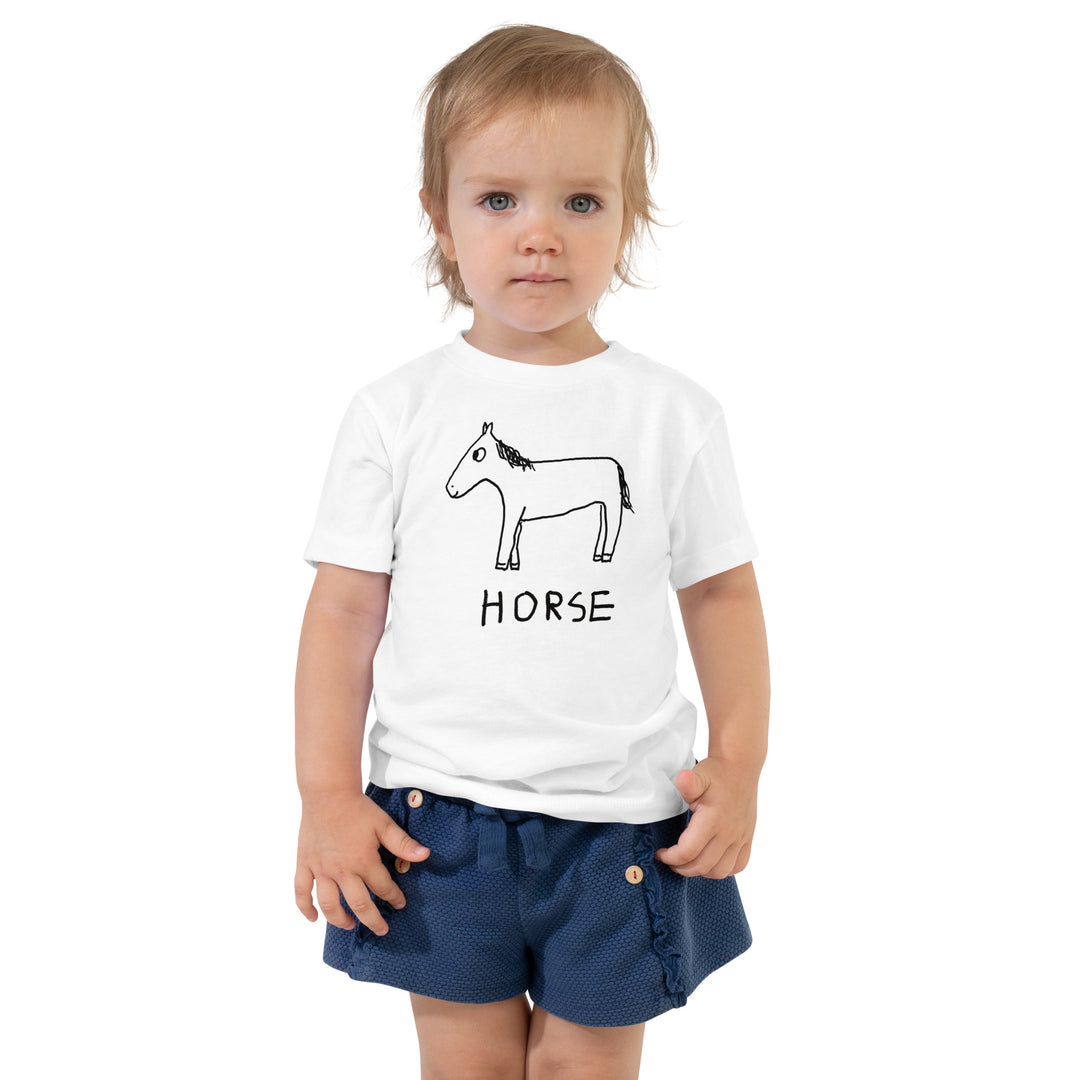 Toddler wearing a white toddler t-shirt with a lo-fi hand-drawn horse graphic and "HORSE" text on a white background. 