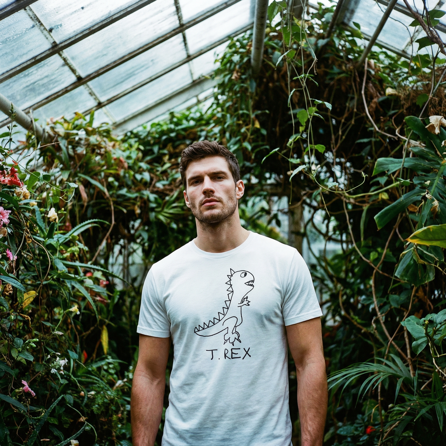 T-Rex shirt worn by handsome man – minimalist lofi dinosaur tee in greenhouse setting