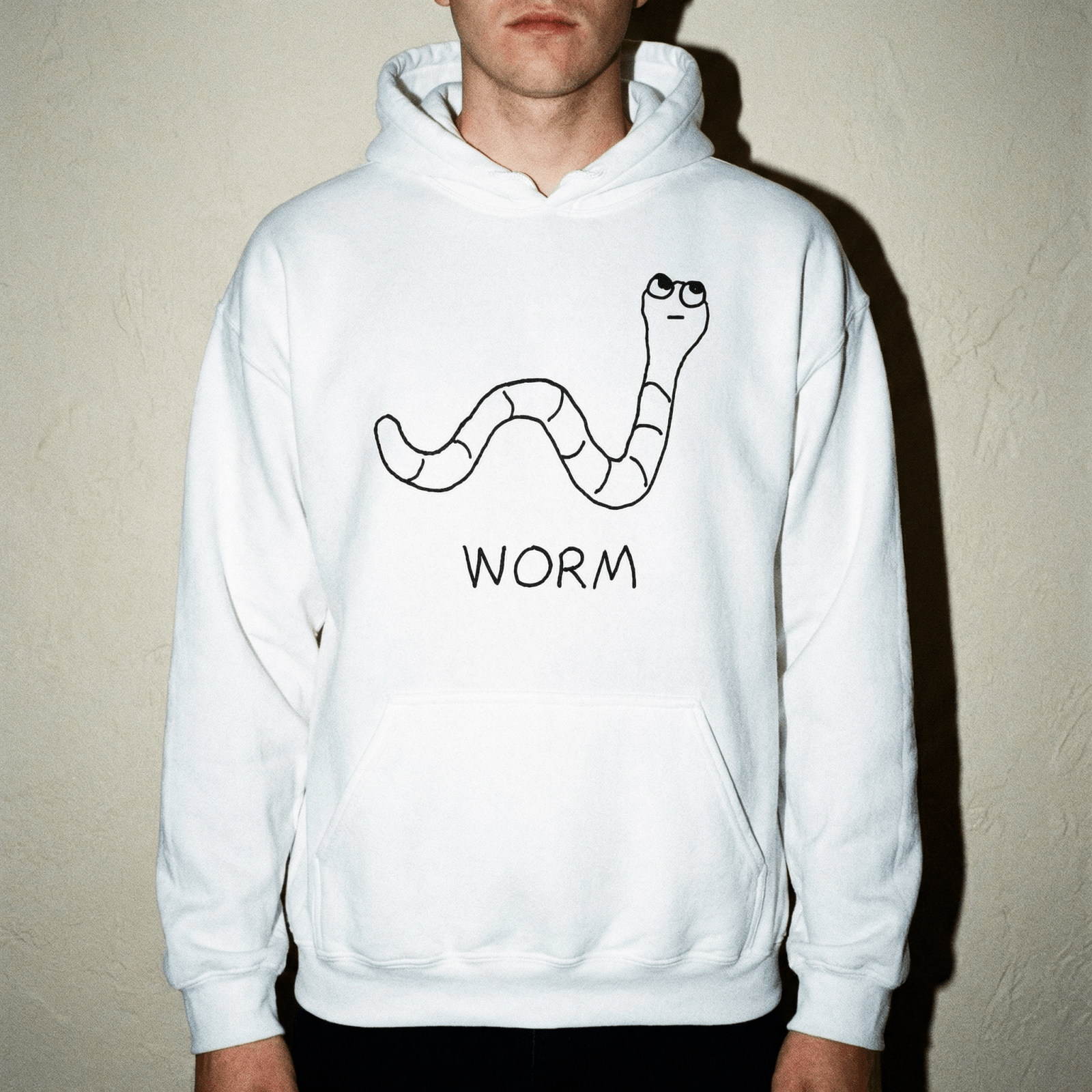 Studio portrait of a man wearing a lo-fi Worm Hoodie