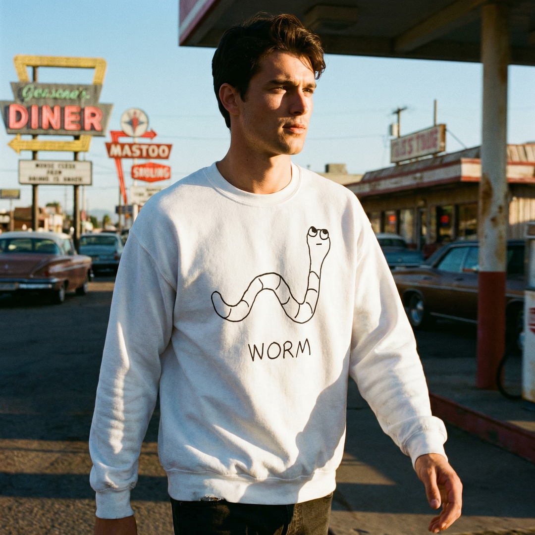 Man wearing a white crewneck sweatshirt with a &