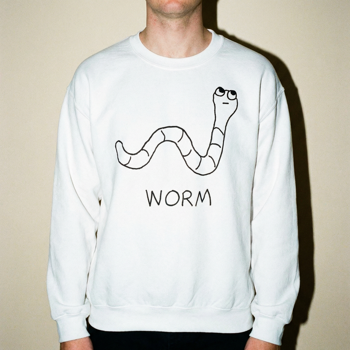 Model in a worm sweatshirt against an earthy beige background, low-key and comfortable